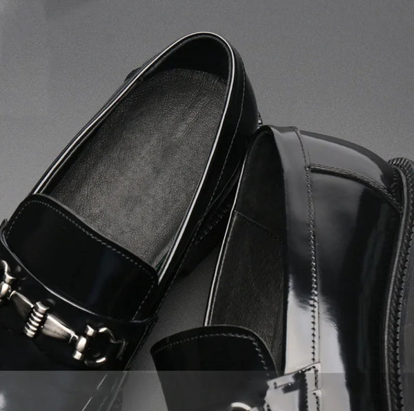 Black Oxfords displayed with a watch for a complete look.