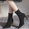 Chic black ankle boots with slim high heels, pointed toe design, perfect for autumn and winter fashion. Stylish slip-on footw