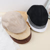 Fashionable beret that enhances urban style with a cultured aesthetic.
