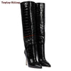Close-up of the pointed toe on chic suede stiletto boots.