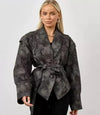Chic belted leather bomber jacket for women, featuring lace-up detail, notched lapel, and hood for stylish autumn wear.