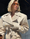 Classic beige trench coat with button-front closure and adjustable belt