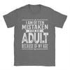 Men's humorous "Mistaken For An Adult" cotton tee, relaxed fit, breathable fabric, perfect for casual wear and gifts.