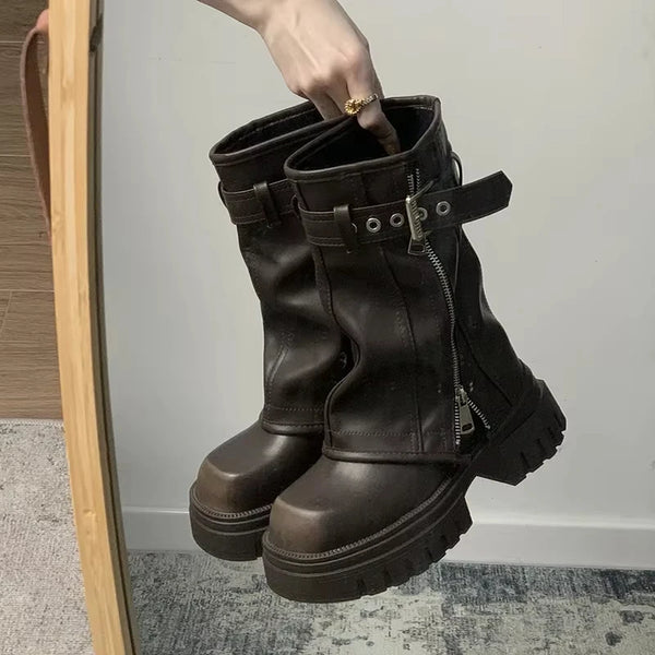 Chic women's mid-calf biker boots with buckle detail, cozy plush lining, and durable rubber sole for stylish winter wear.