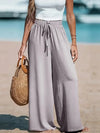 Flowing polyester beach pants with tatting details and ankle-length cut