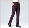 Professional in stretch business pants bending comfortably during active work tasks
