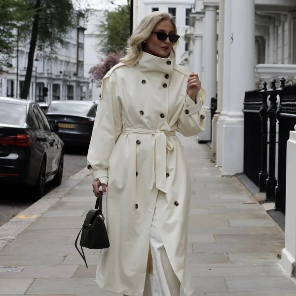 Elegant cream trench coat front view highlighting tie belt and button details