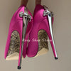 Side view of black pointed toe stiletto pumps with crystal details.