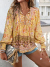 Bohemian lace-up V-neck blouse for women in vibrant print, featuring lantern sleeves and a loose fit, perfect for spring and