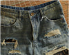 Rebel Spirit Distressed Jeans worn with a graphic tee, showcasing casual denim style.
