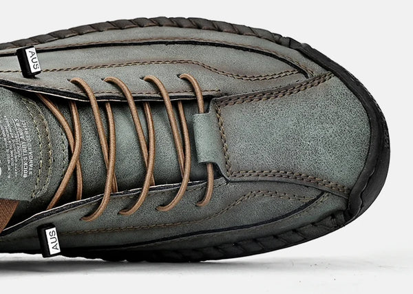 Man's feet in brown leather loafers on urban pavement showing durable traction and grip performance