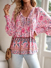 Bohemian lace-up V-neck blouse for women with vibrant print, lantern sleeves, and loose fit, perfect for spring and summer.