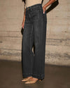 Chic high-waisted wide-leg jeans for women, featuring a relaxed fit, distressed details, and practical pockets for stylish co