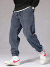 Thermal corduroy joggers with fleece lining in neutral color on white background