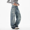 Trendy washed and ripped wide-leg women's jeans with distressed ink-splashed finish for a chic, casual look.