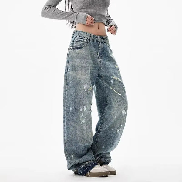 Trendy washed and ripped wide-leg women's jeans with distressed ink-splashed finish for a chic, casual look.