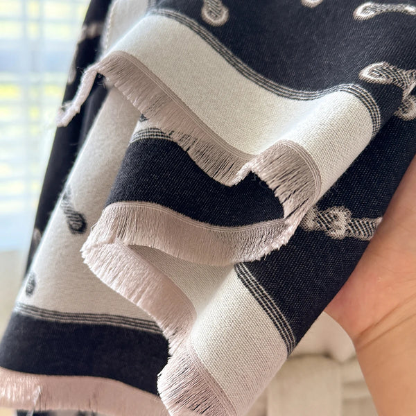 Versatile cashmere shawl draped elegantly, showcasing its floral artistry.