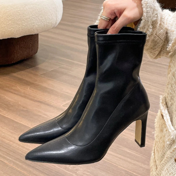 Chic black ankle boots with slim high heels, pointed toe design, perfect for autumn and winter fashion.
