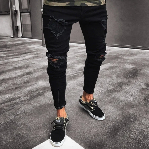 Side view of black jeans with zipper details and casual fit.