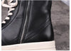 Black leather boots with tough rubber soles for practical protection.