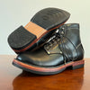Ankle height of retro style boots with thick rubber sole.