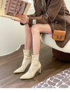 Chic black ankle boots with slim high heels, pointed toe design, perfect for autumn and winter fashion. Stylish slip-on footw