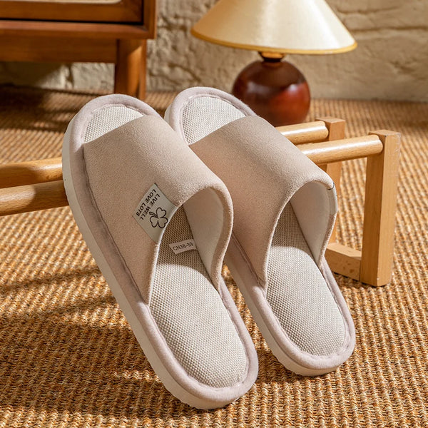 Person curled up reading with feet in cozy linen slippers