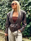 Chic belted leather bomber jacket for women, featuring lace-up detail and hood, perfect for autumn and winter fashion.