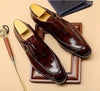 Close-up of the polished finish on dapper carved Oxford shoes.