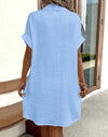 Detail shot of dress V-neckline showing elegant cut and soft fabric drape