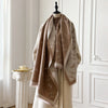 Luxurious cashmere shawl with unique floral artwork, perfect for layering.