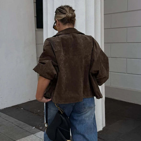 Black oversized faux leather bomber jacket with turn-down collar and functional pockets