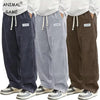 Relaxed fit corduroy drawstring pants in neutral color with elastic waistband and textured fabric