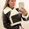 Chic cropped leather and wool blend jacket for women with fur trim, zipper closure, and stylish turn-down collar.