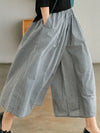 Chic plaid wide-leg pants in cotton-linen blend, featuring a high waist, pockets, and elastic waistband for comfort.