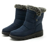 Chic women's waterproof winter boots with plush lining, low heel, and hook-and-loop closure for stylish cold weather comfort.