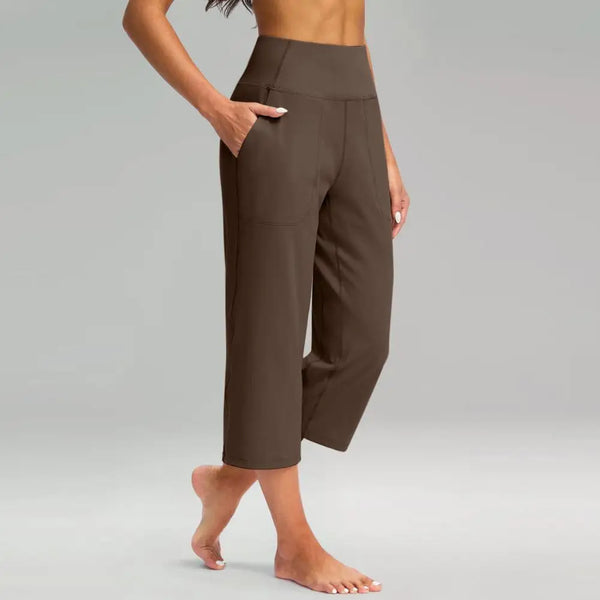 Chic high-waist wide-leg capri yoga pants with pockets for versatile activewear and casual style in nylon-spandex blend.