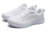 Cushioned white athletic sneakers with multi-color details for active wear