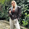 Chic belted leather bomber jacket for women, featuring lace-up detail and hood, perfect for autumn and winter fashion.