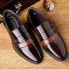 Close-up of brogue detailing on elegant black leather Oxford shoes.