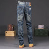 Close-up of men's vintage wash straight jeans showcasing durable zipper fly.