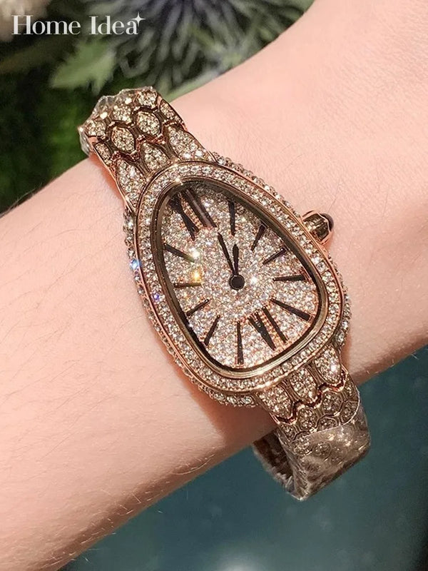 Luxury diamond-studded watch with a snake-patterned stainless steel band.