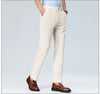 Navy blue dress pants styled smart-casual with sneakers for versatile professional look