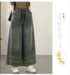 Vintage embroidered wide-leg jeans for women, featuring elastic waist, ethnic design, and light wash for autumn fashion.