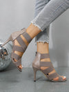 Elegant navy blue stiletto sandals with true to size fit and zip closure.