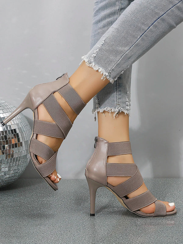 Elegant navy blue stiletto sandals with true to size fit and zip closure.