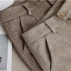 High-waist button suit pants in neutral color with tailored fit and functional pockets for professional wear