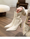 Chic black ankle boots with slim high heels, pointed toe design, perfect for autumn and winter fashion.