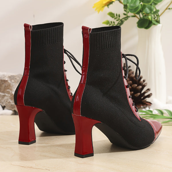 Chic black and red pointed toe lace-up booties with block heel for stylish comfort in all seasons and occasions.