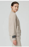 Luxurious loose fit wool cardigan featuring expert rib knit construction and elegant silhouette